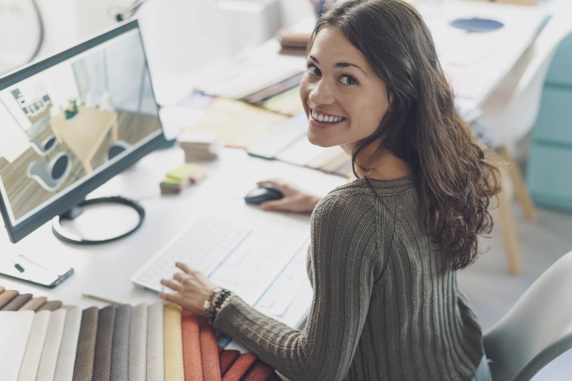 smiling-interior-designer-working-at-desk-1.jpg